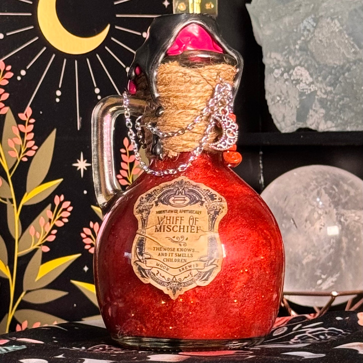 Red potion bottle labeled 'Whiff of Mischief' with decorative background