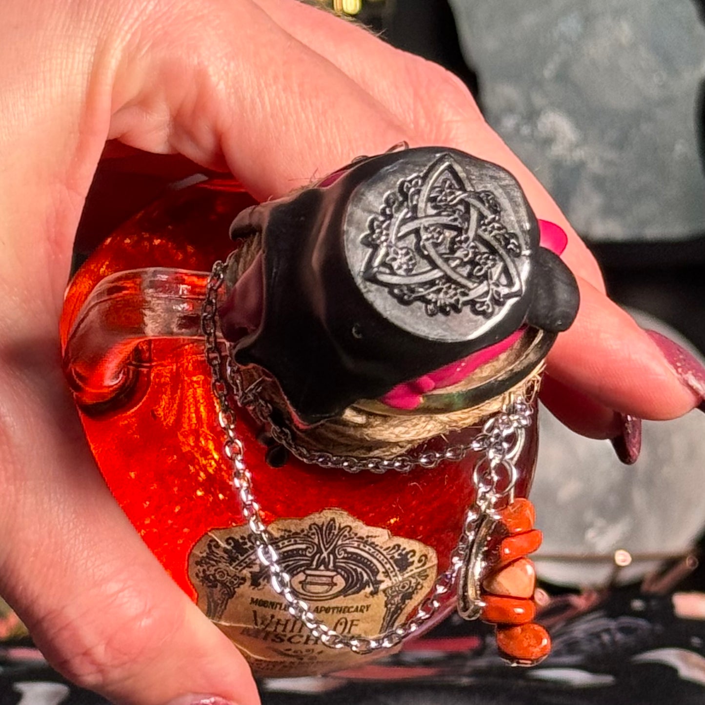 Small bottle with a decorative cap held by a hand