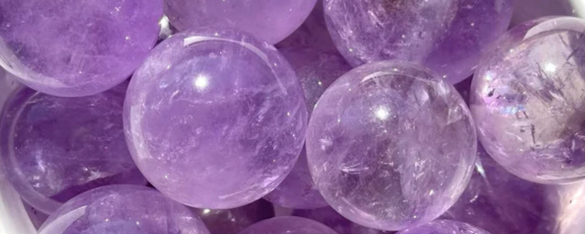 amethyst spheres in a stone bowl