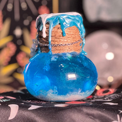 Blue glass bottle with cork stopper on a colorful background