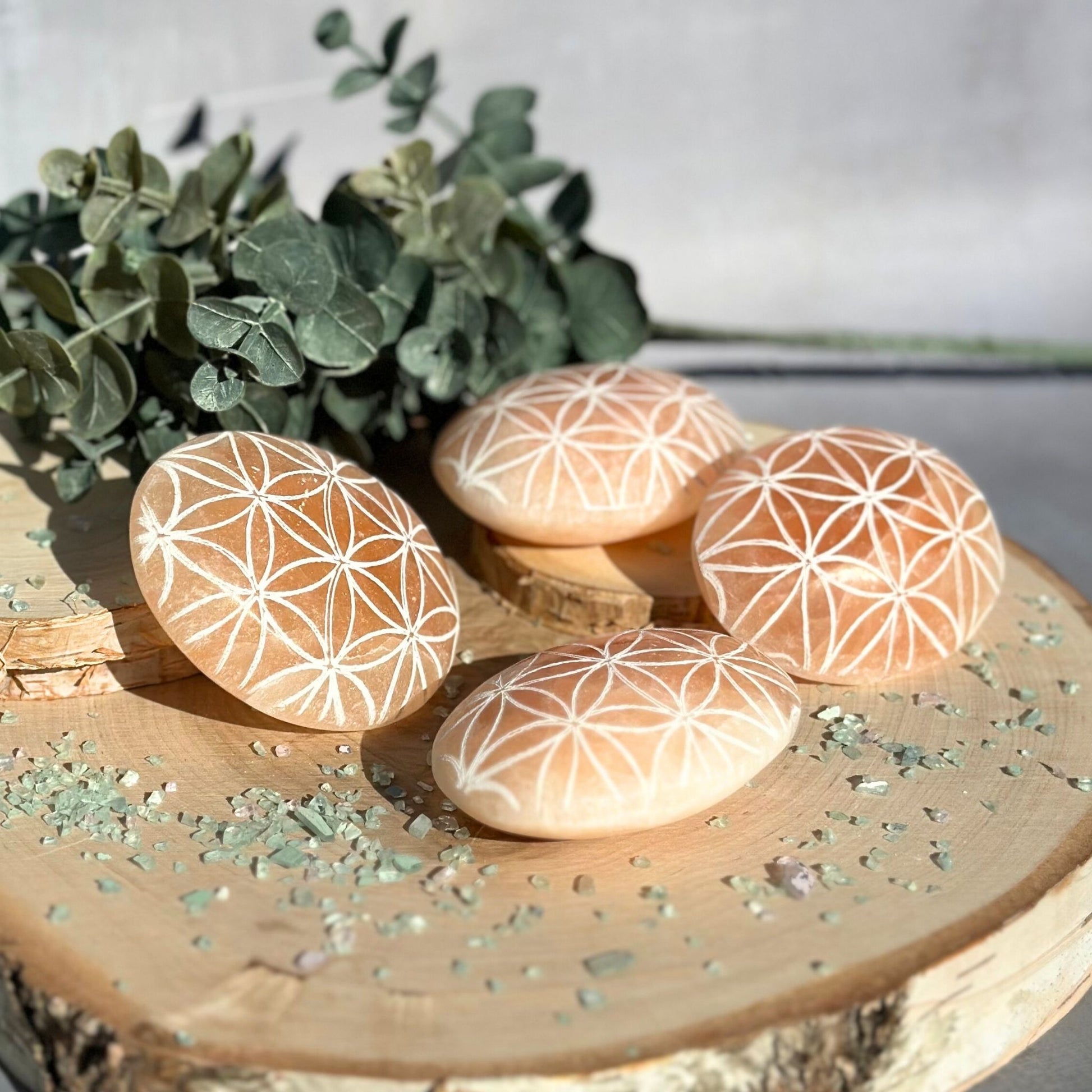 orange selenite palm stones flower of life