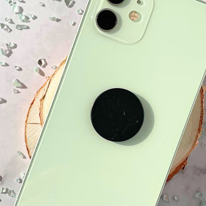 Shungite tile attached to mint phone case