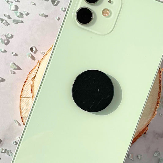 Shungite tile attached to mint phone case