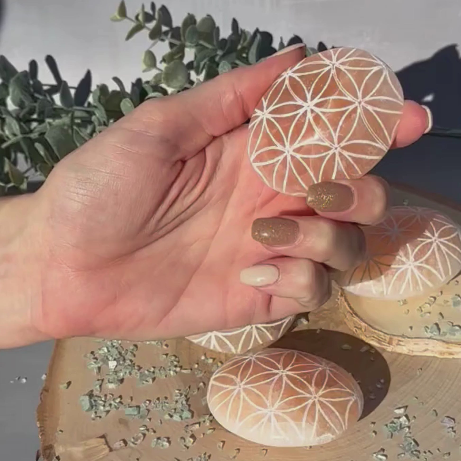 orange selenite palm stones flower of life